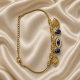 Gold Evil Eye Charm Bracelet Blue Crystal Teardrop Pavé Nazar Snake Chain - vertical straight lay on cream satin: full bracelet extended showing complete charm sequence eye-teardrop-pavé evil eye-teardrop-eye on alternating textured barrel and smooth round bead stations, fine-ridge snake chain, lobster clasp and long curb link extension chain, cream satin background