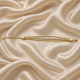 Gold Three Row Bracelet Crystal Tennis Centre Ball Bead Chain Lobster Clasp - extended horizontal flat lay on cream satin: bracelet fully extended in straight lay showing complete three-row construction from tapered shield end cap on left through full bead-crystal-bead parallel row length to lobster clasp and extension chain on right, all three rows visible in parallel at full bracelet length, cream satin background