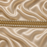 Gold Cuban Link Chain Bracelet Double Crystal Tennis Row Three Row Shield Clasp - clasp detail flat lay on cream satin: close-up of tapered warm gold shield end cap gathering all three bracelet rows into single unified terminal, lobster clasp on right with jump ring, full flat-faced Cuban link centre and crystal tennis row detail visible, cream satin background