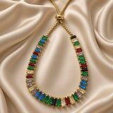 Gold-tone multicolour adjustable bracelet worn on a woman's wrist