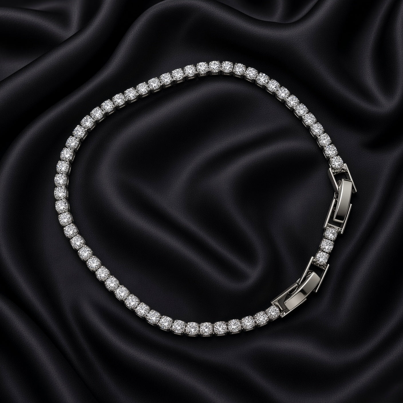 Close-up of silver-tone crystal tennis bracelet with fold-over clasp on black satin
