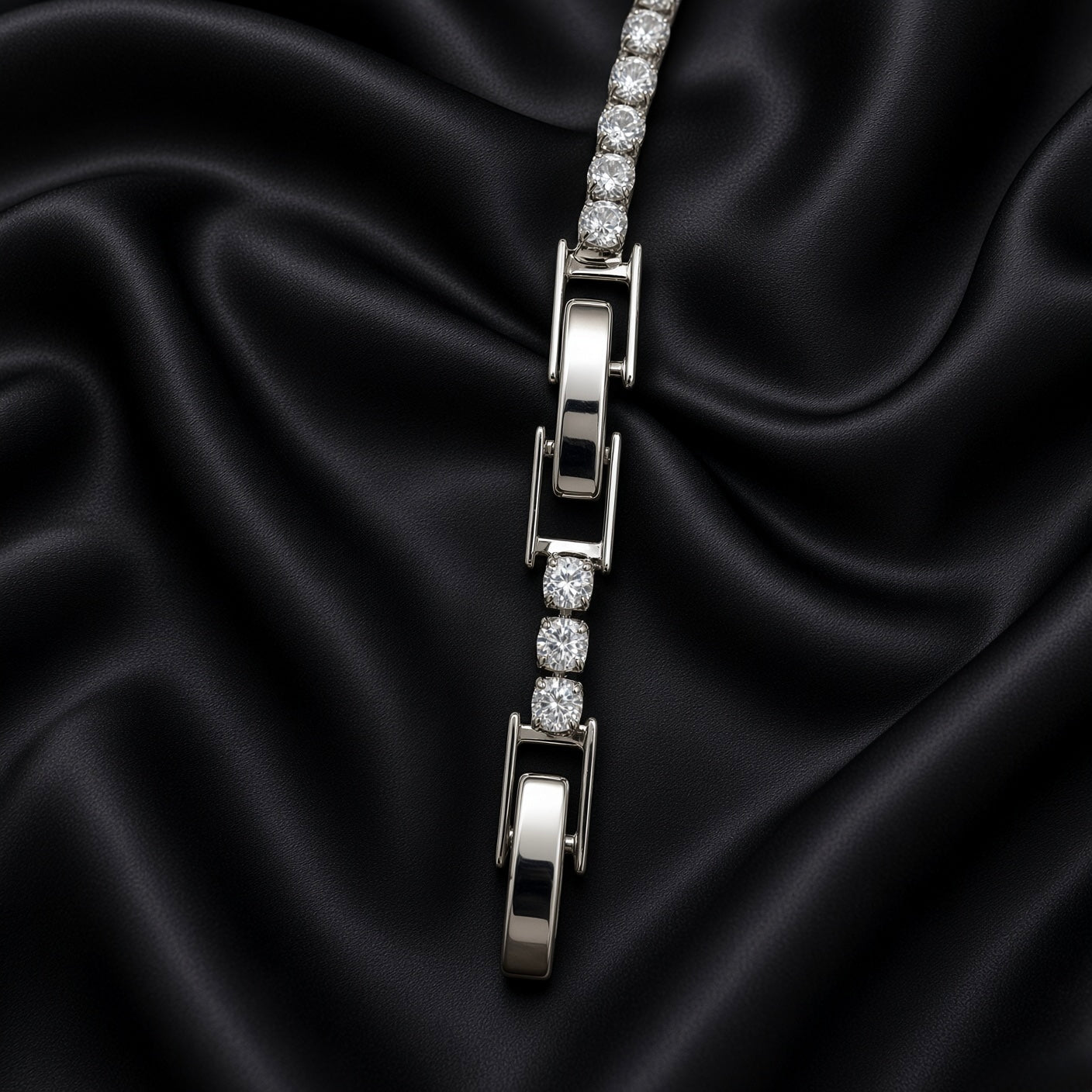 Silver-tone tennis bracelet with clear round crystal-style stones arranged on black satin