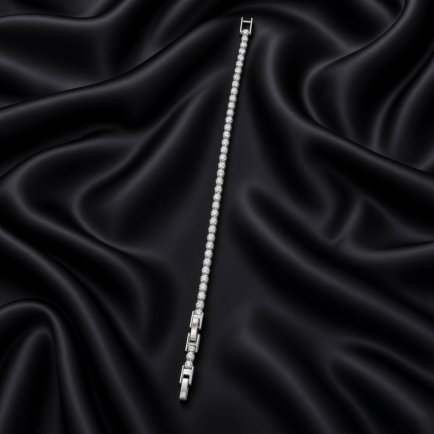 Full-length view of slim silver-tone crystal tennis bracelet on black satin