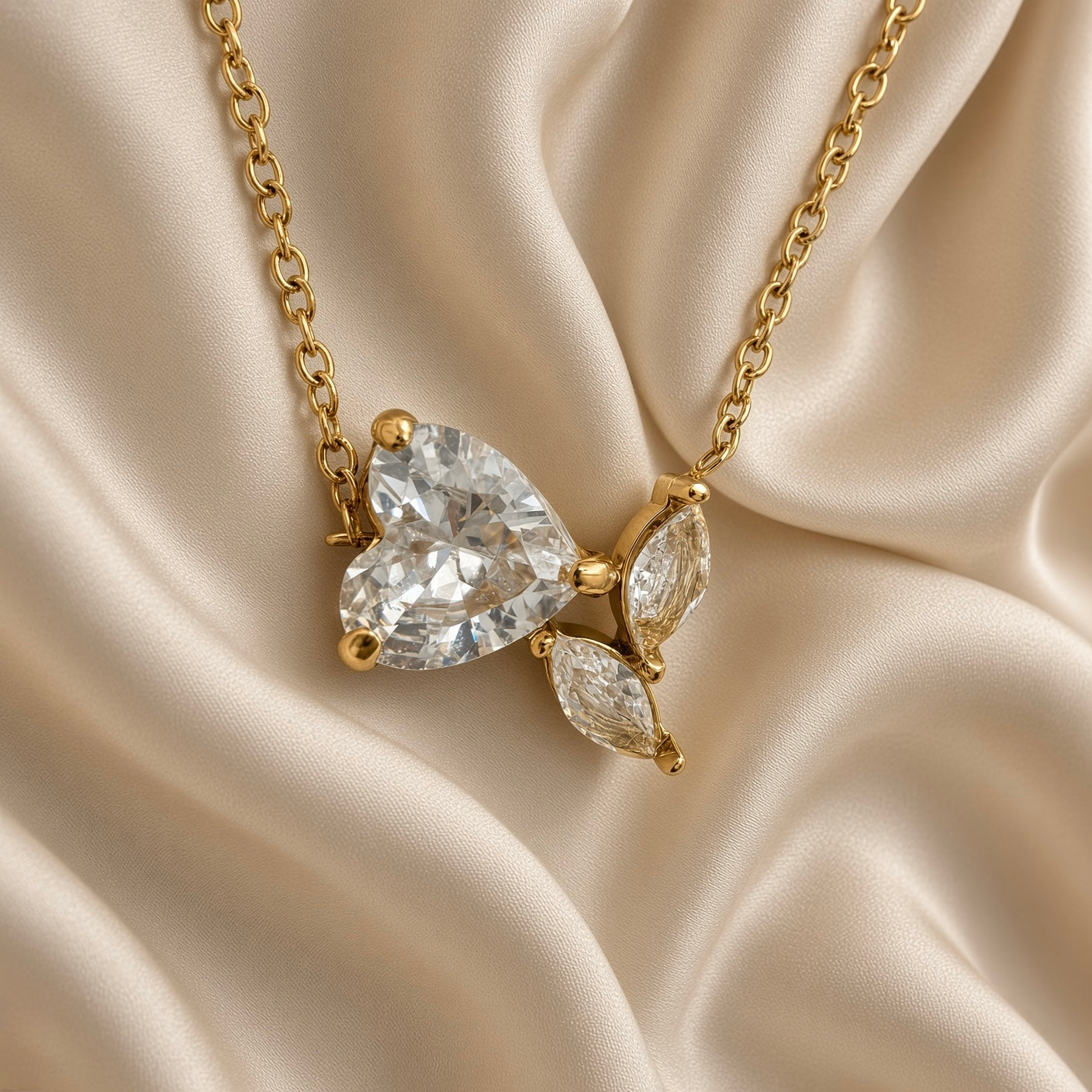 Close-up of clear heart-shaped stone and butterfly detail on a gold-tone necklace
